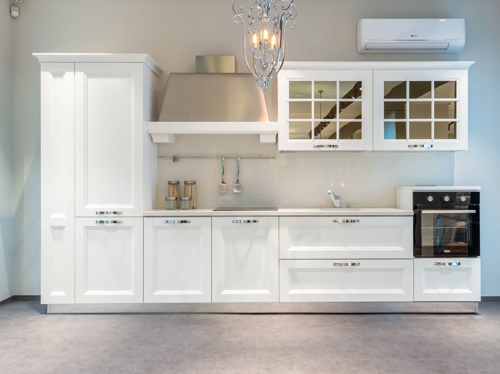 white kitchen furniture and modern appliances in apartment